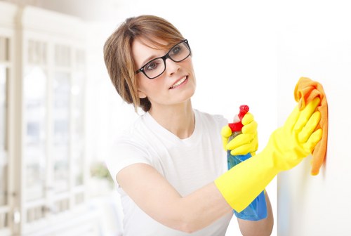 Team member wearing PPE while inspecting a carpeted area before cleaning